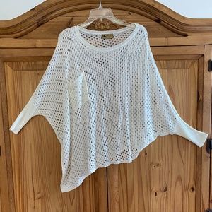 Boat neck sweater top with holes.